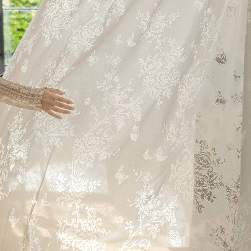 a woman standing in front of a white curtain