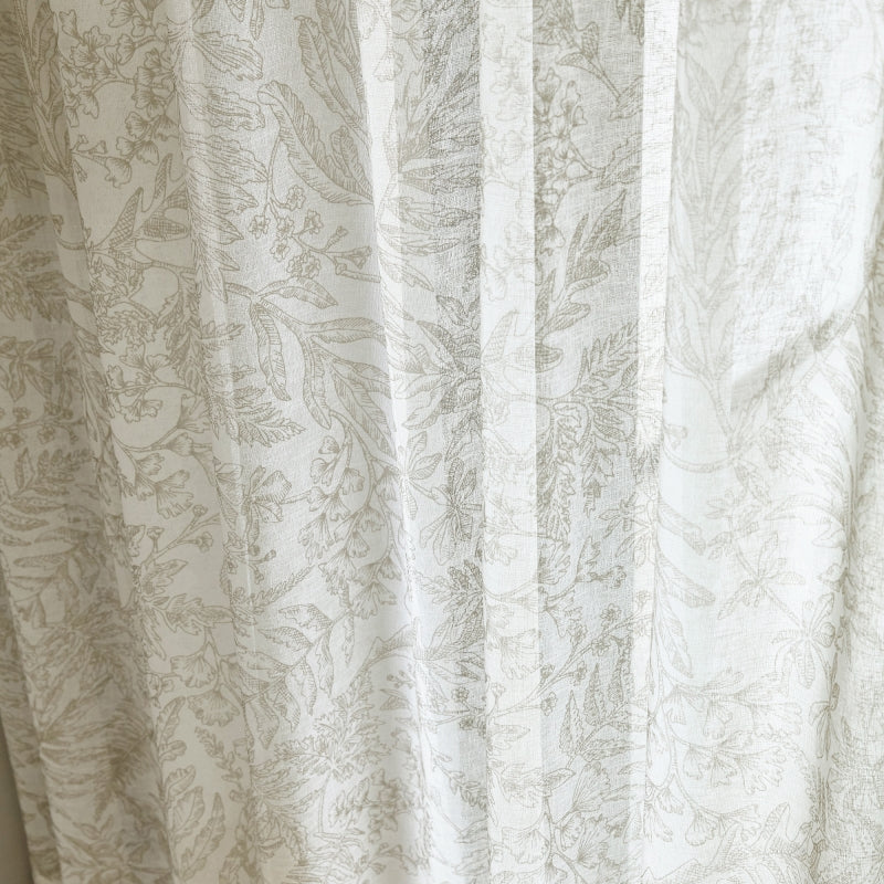 a close up of a curtain with a cat on it