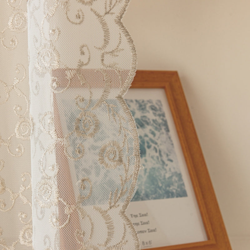 a picture frame and a curtain hanging on a wall