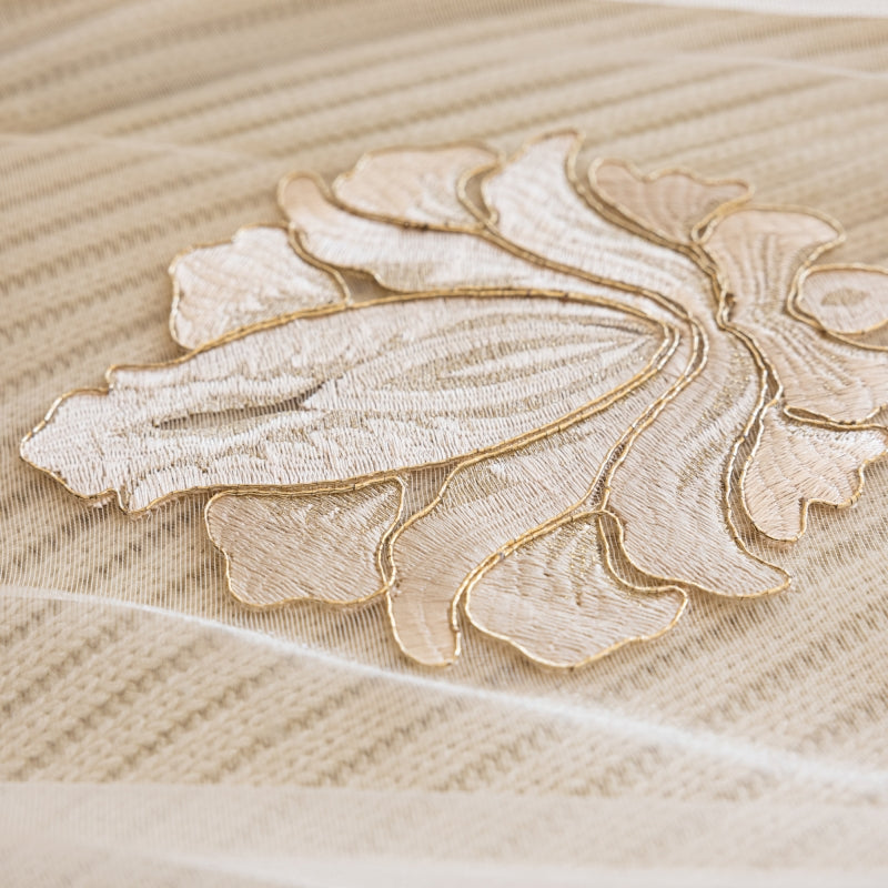 a close up of a bed with a decorative design on it