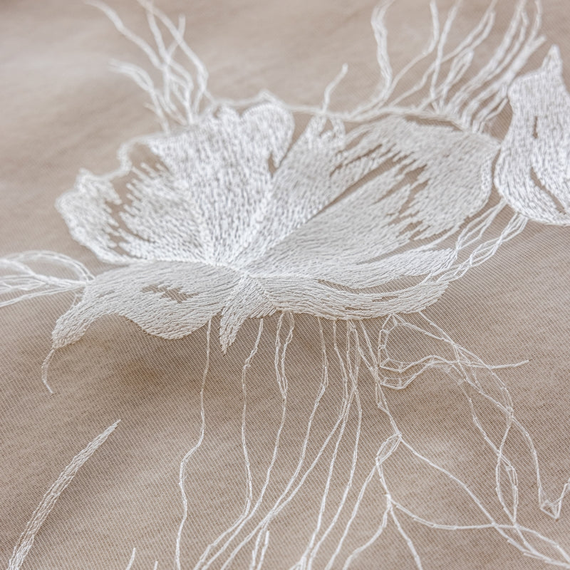 a close up of a flower on a cloth