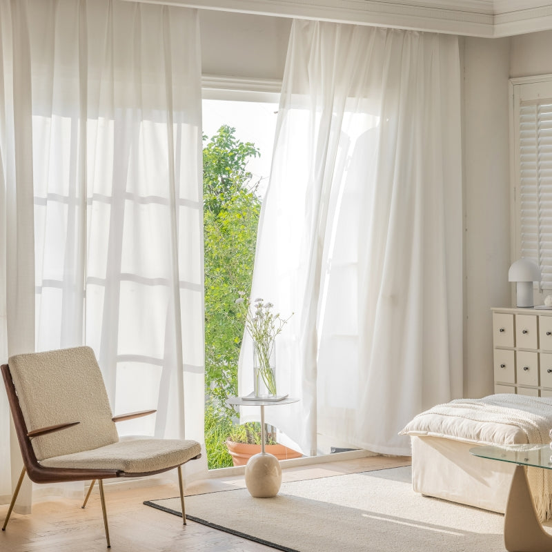 a bedroom with a bed, chair and window