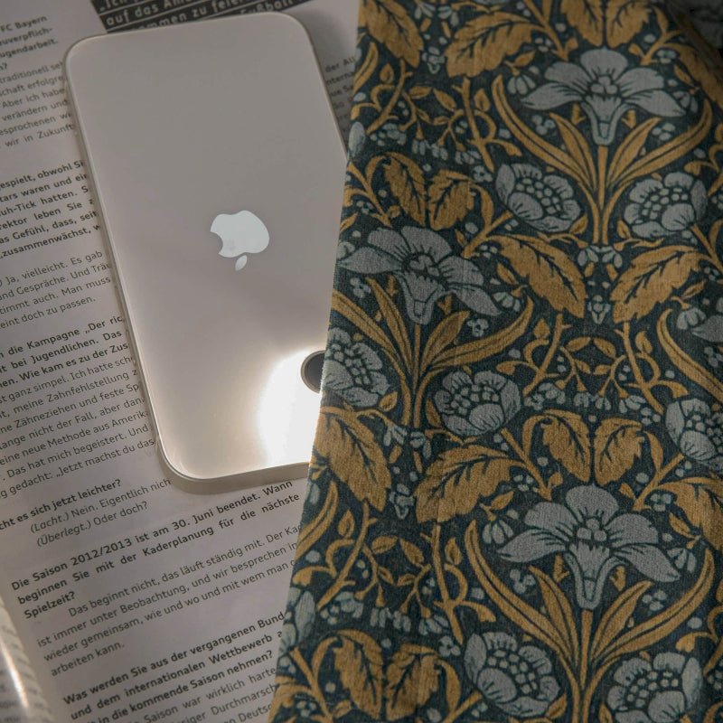 an apple computer sitting on top of a book