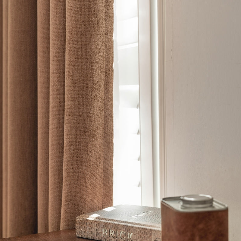 a book sitting on top of a wooden table next to a window