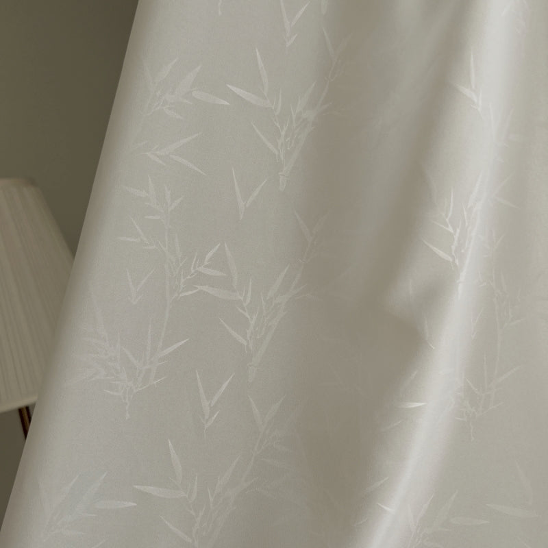a lamp is next to a white curtain