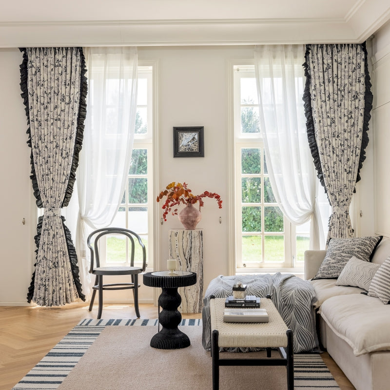 a living room filled with furniture and a large window