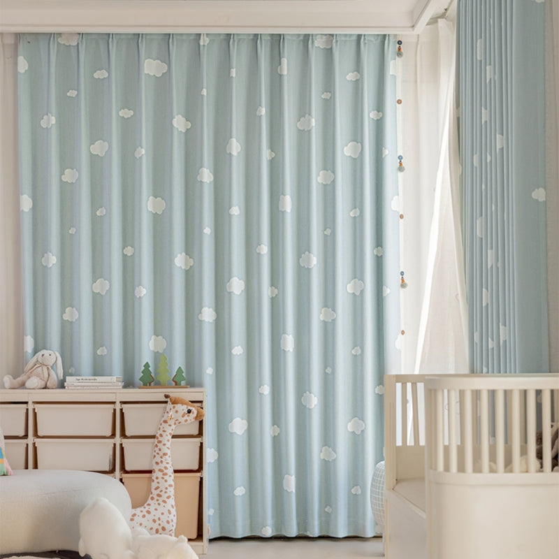 a baby's room with blue curtains and a white crib
