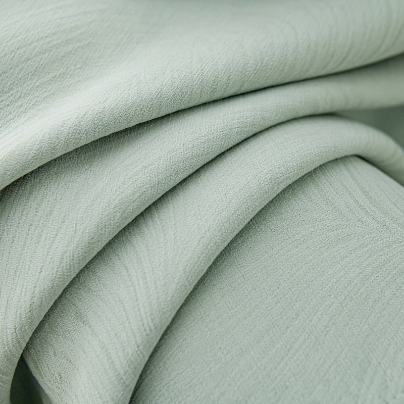 a close up of a light green fabric