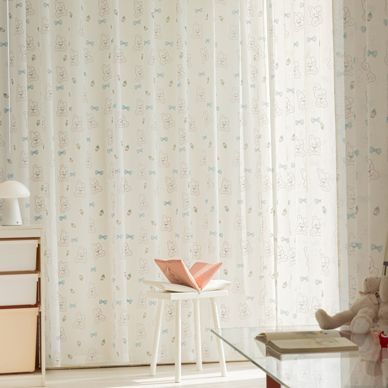 a teddy bear sitting on a stool next to a window