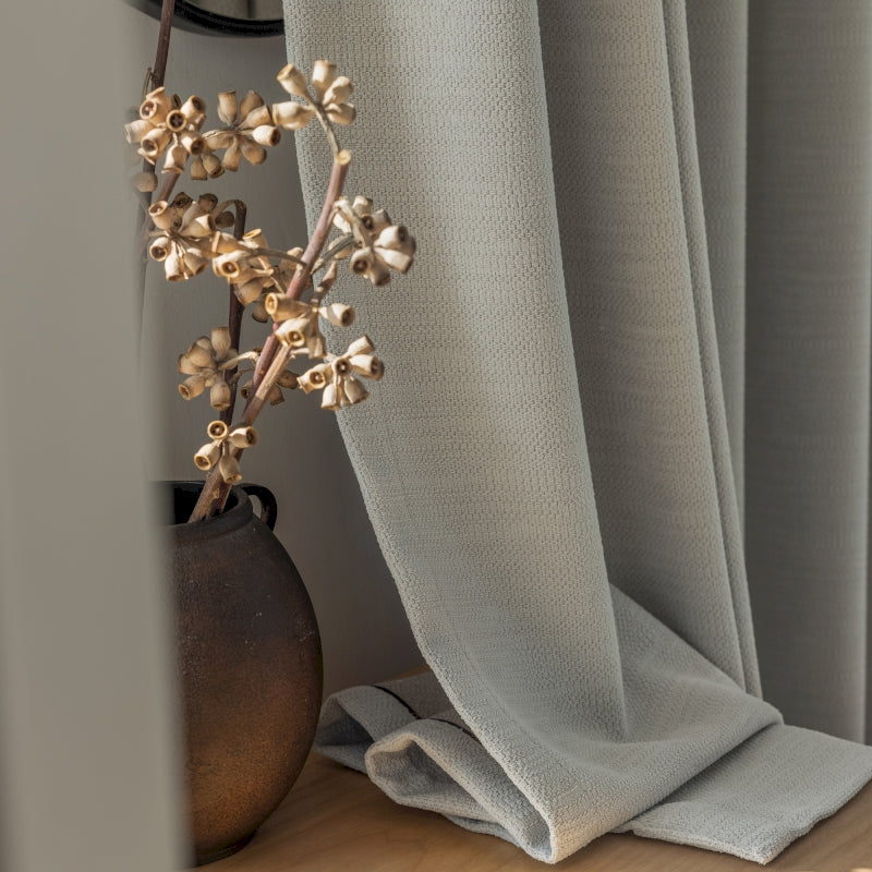 a close up of a flower on a curtain