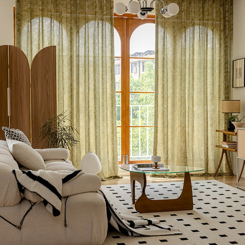 a living room filled with furniture and a large window