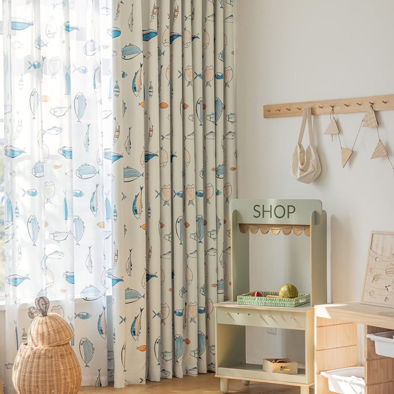 a child's room with a wooden table and a curtain