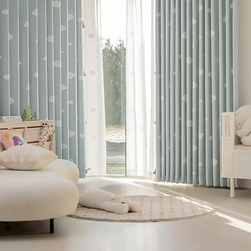 a bedroom with a white bed and blue curtains