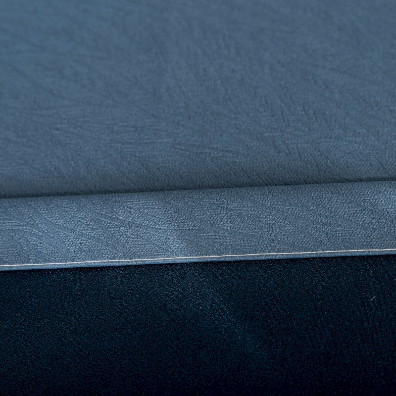 a close up of a blue sheet on a bed