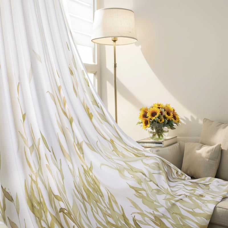 sunflowers in a vase on a table in front of a curtain