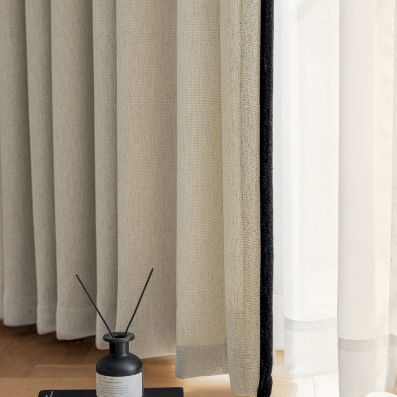 a black and white vase sitting on top of a wooden floor