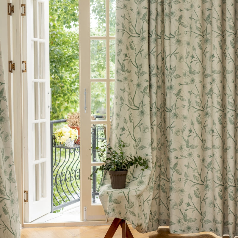 a chair sitting in front of a window next to a potted plant