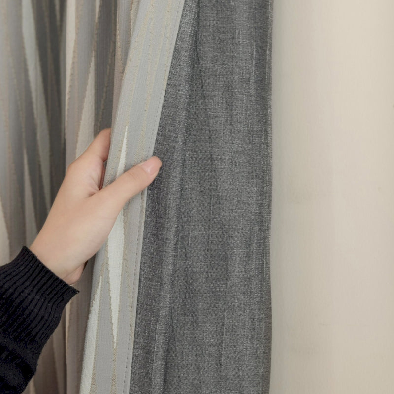 a person holding a curtain with their hand