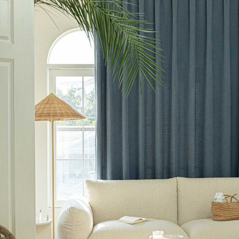 a living room with a white couch and a palm tree
