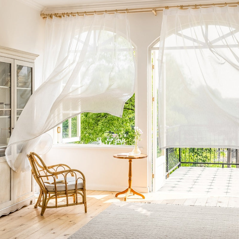 a living room with a chair and a window