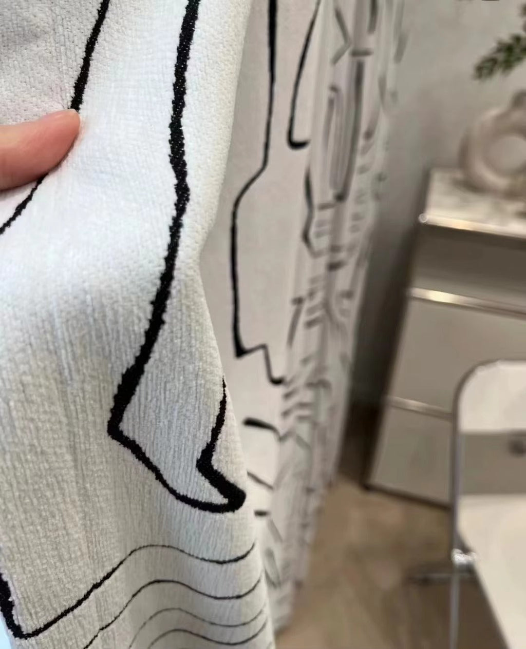 a person is holding a shower curtain in a bathroom