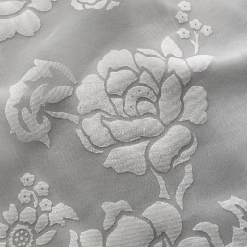 a close up of a white flower on a gray background