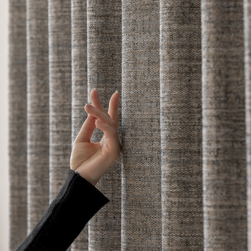a person's hand reaching up from behind a curtain