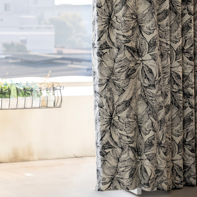 a curtain with a black and white flower pattern