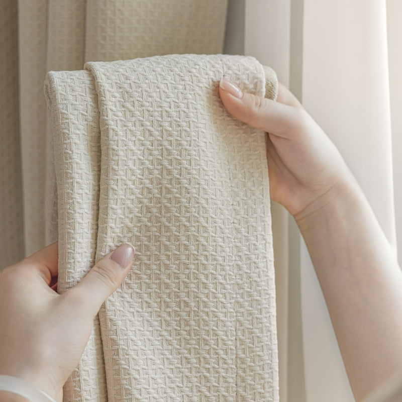 a person holding a white towel in front of a window
