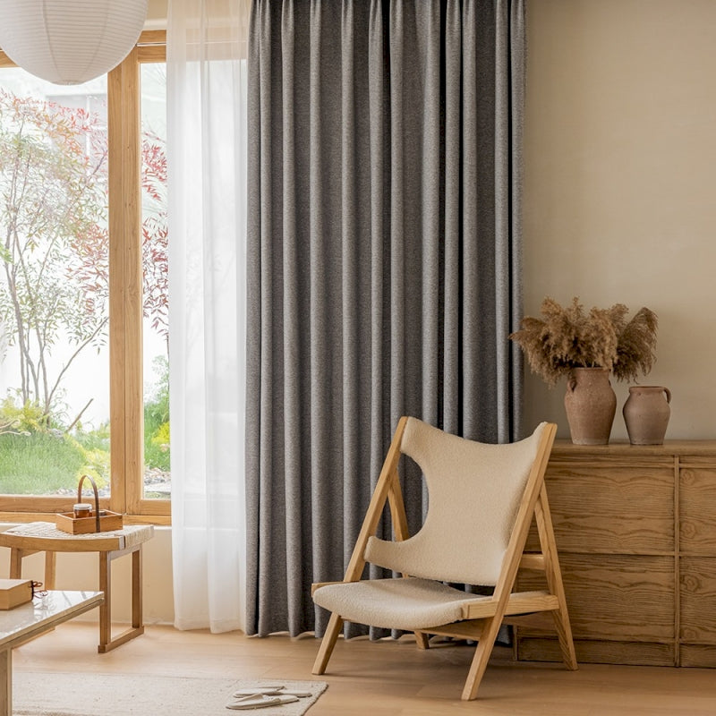 a living room with a chair and a window