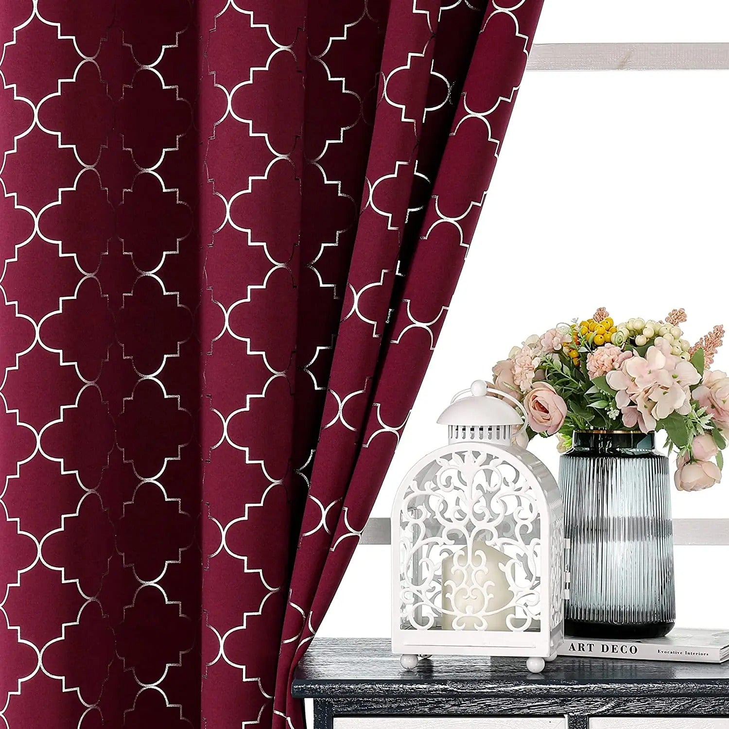 a vase of flowers sitting on a table next to a window