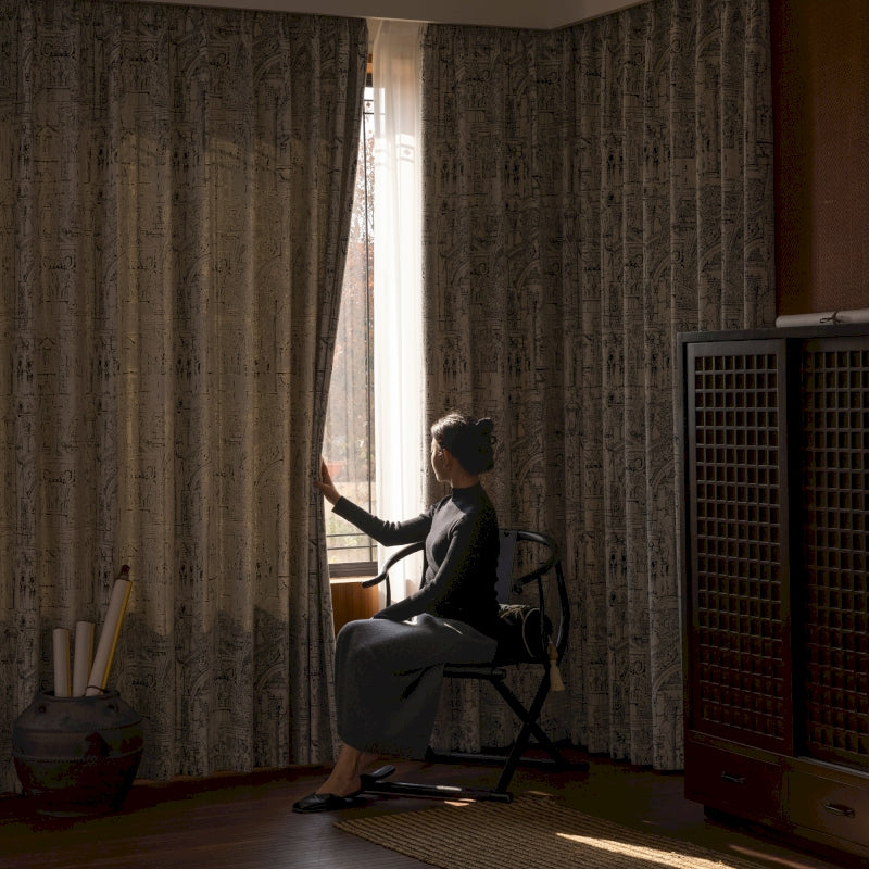 a woman sitting in a chair in front of a window