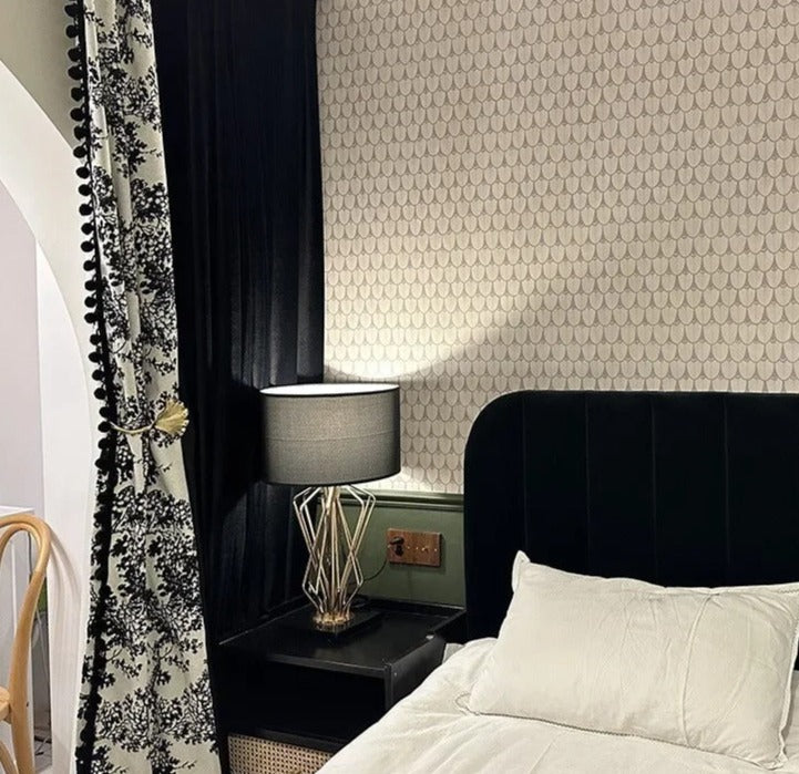 a bedroom with a black headboard and a white bed