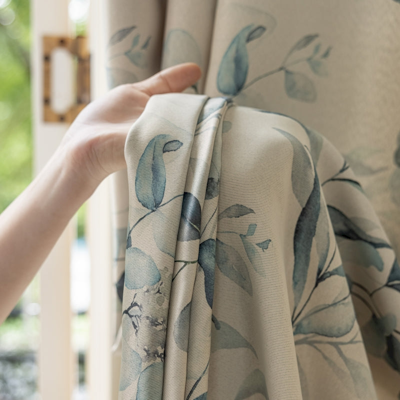a person holding a curtain with a flower pattern on it