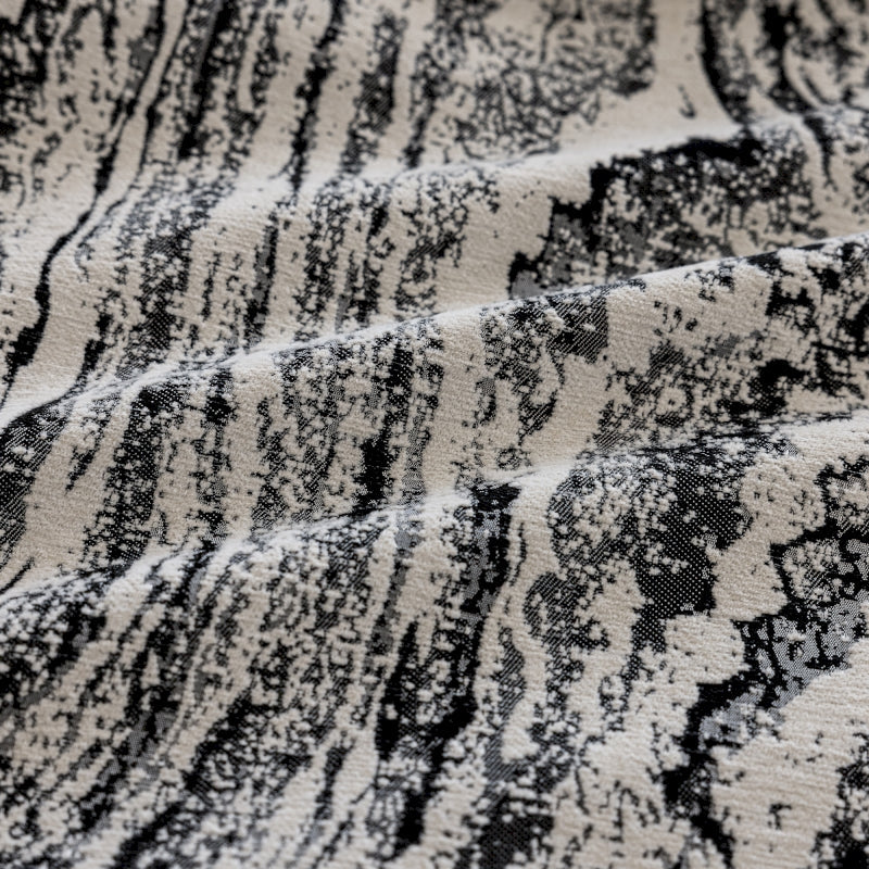 a close up of a black and white rug