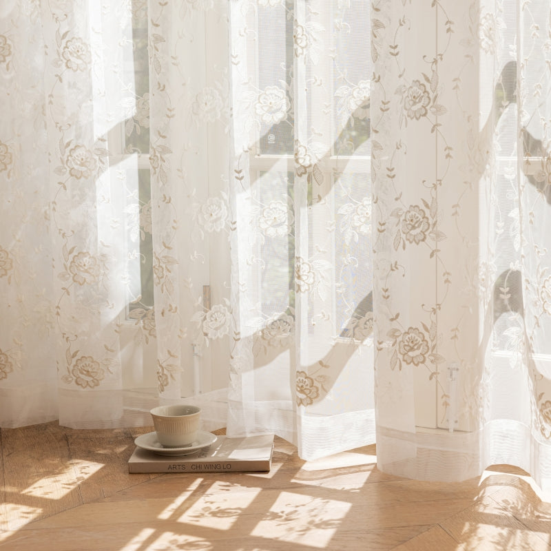 a cup and saucer sitting on a table in front of a window