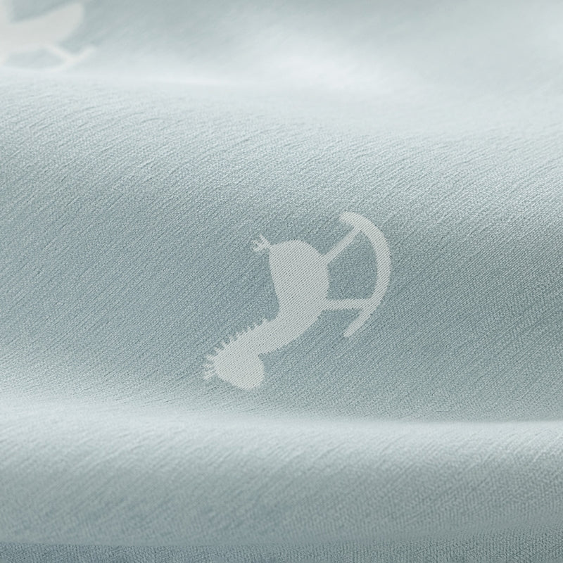 a close up of a shirt with a bird on it