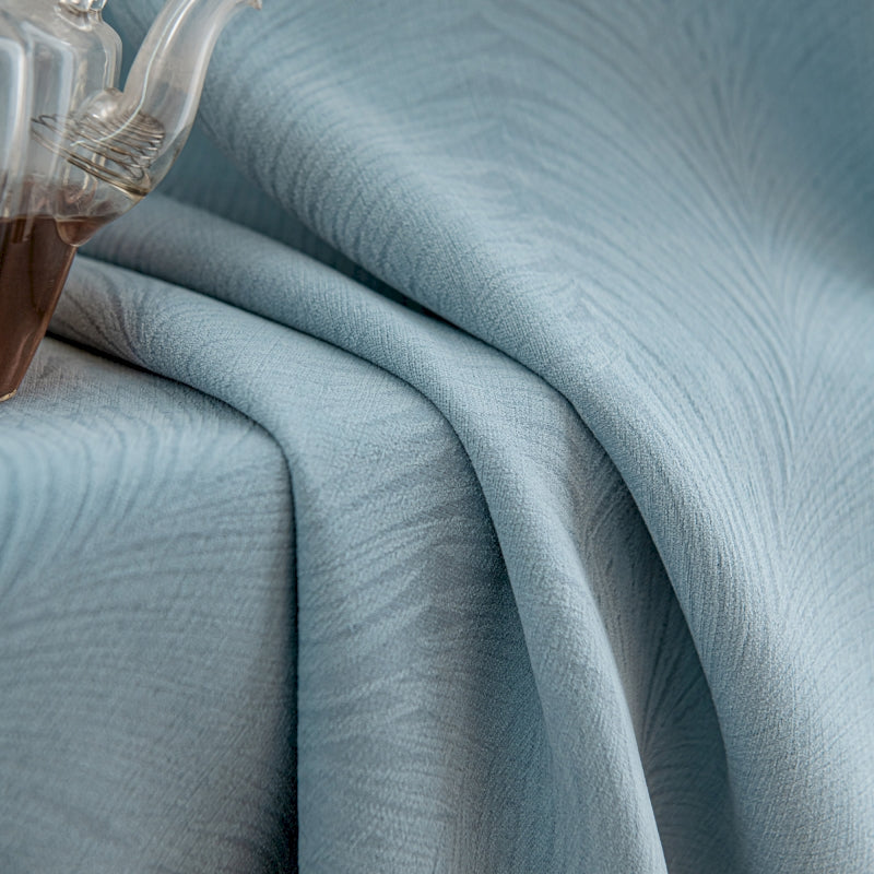 a bed with a blue bedspread and a teapot on top of it