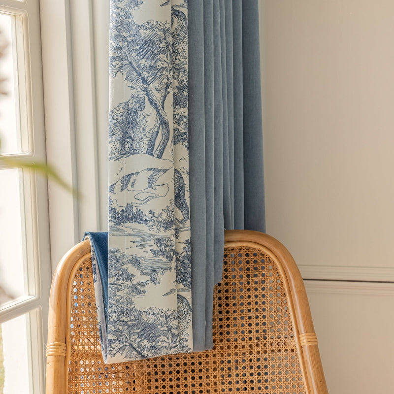 a blue and white curtain hanging from a window