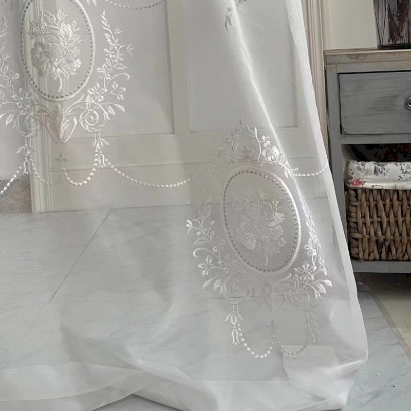 a white curtain with a design on it