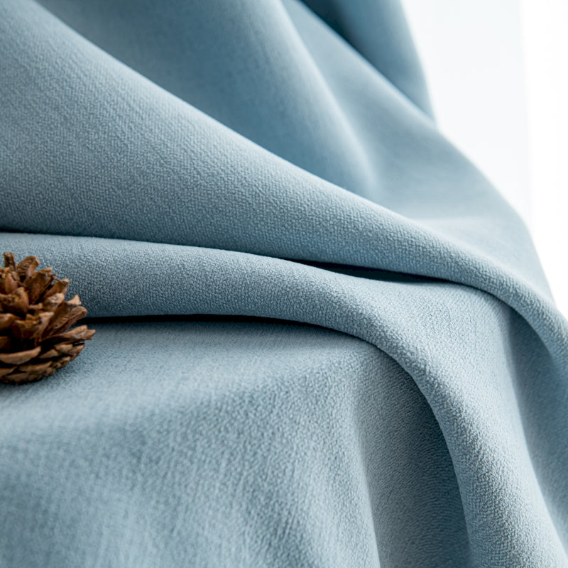 a pine cone is sitting on a blue blanket