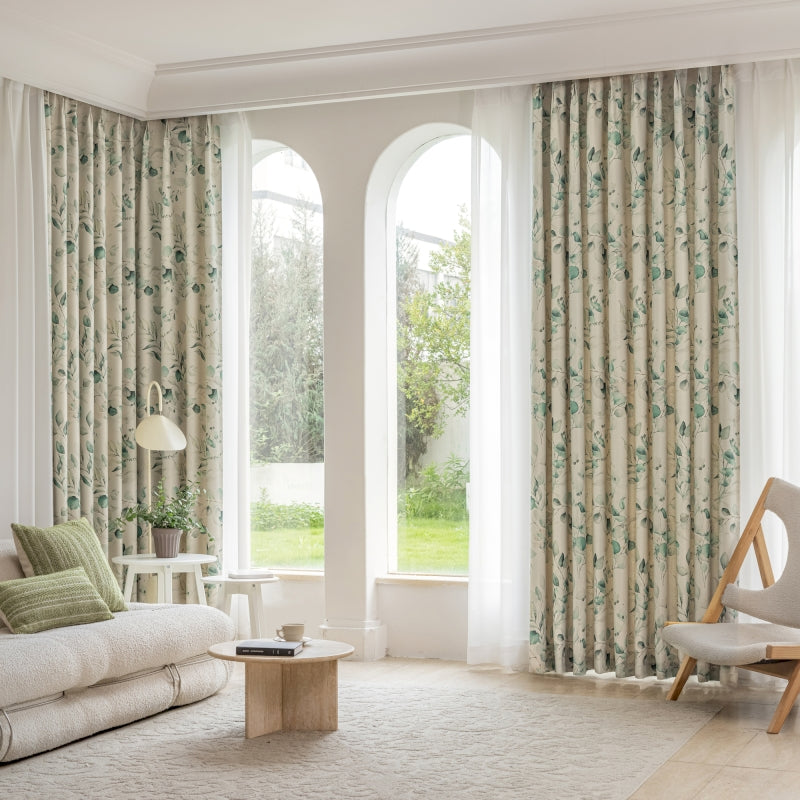 a living room filled with furniture and large windows