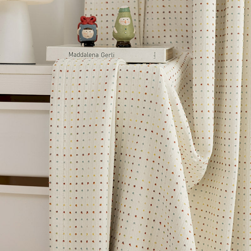 a close up of a bed with a curtain