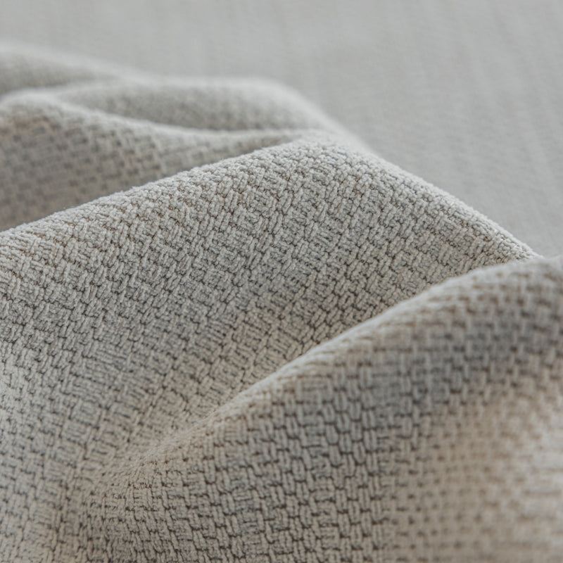 a close up of a bed with a white blanket
