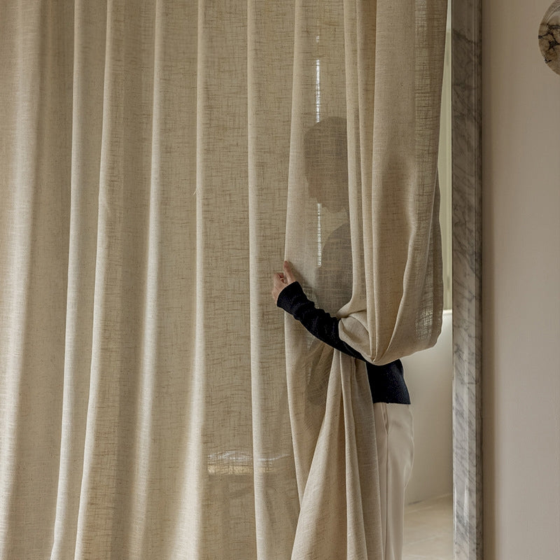 a person standing behind a curtain in a room
