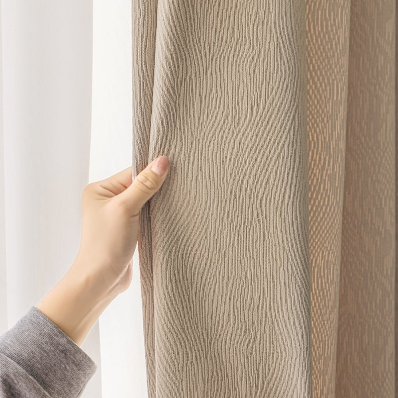 a person is opening the curtains with their hand