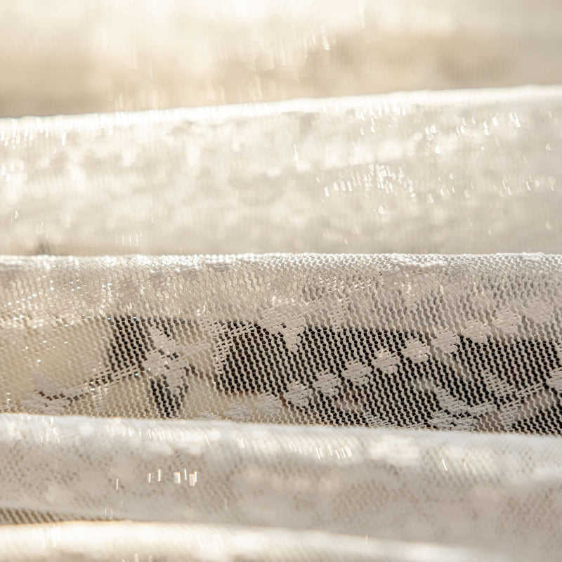 a close up of a baby crib with white sheets