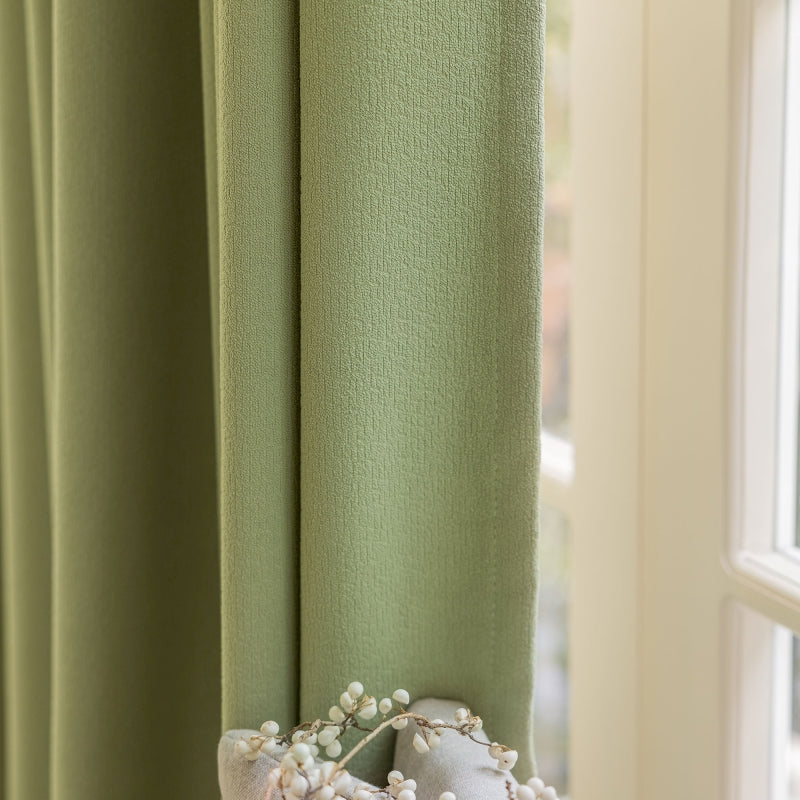 a close up of a window with a curtain