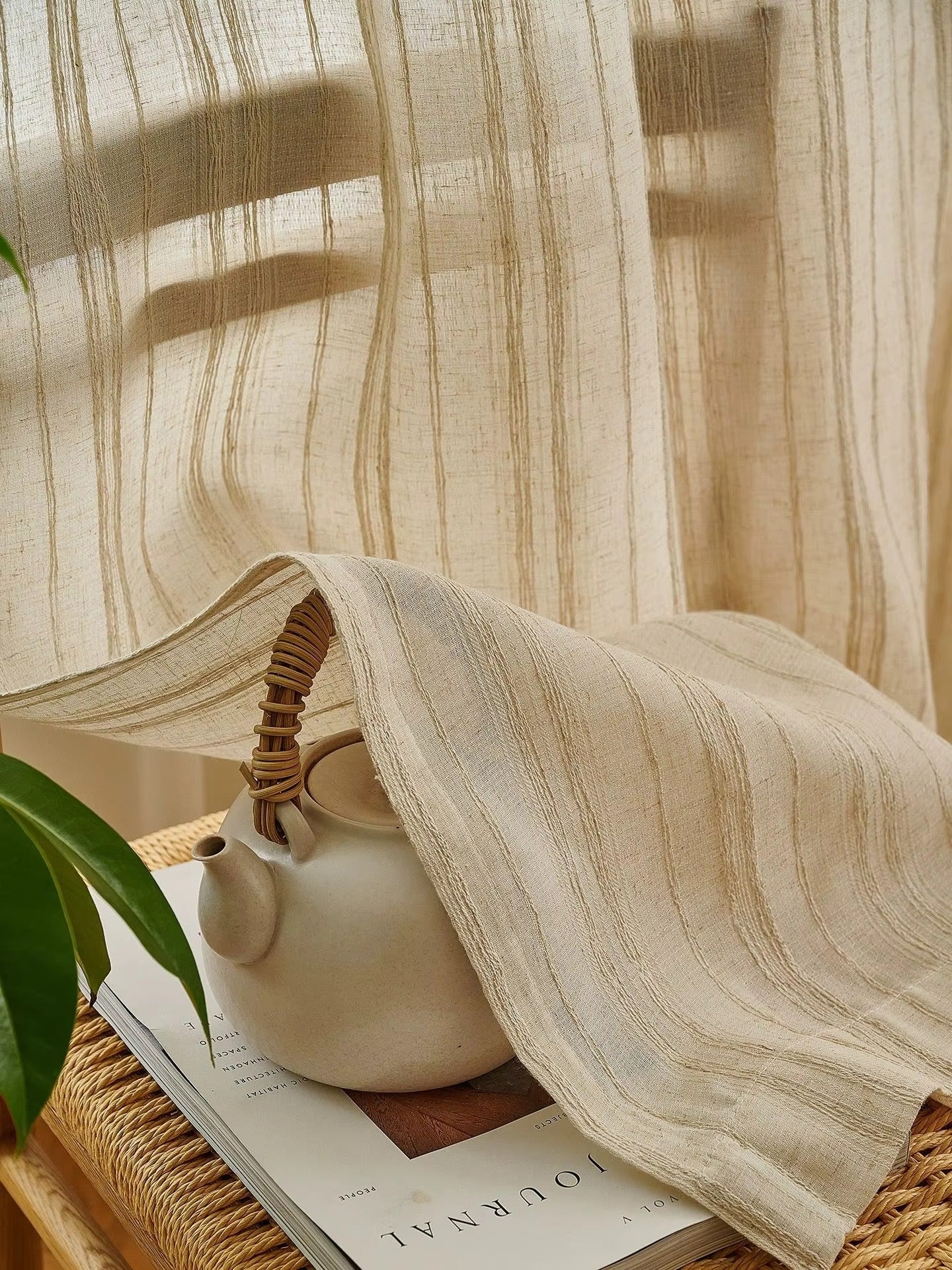 a white tea pot sitting on top of a wooden table