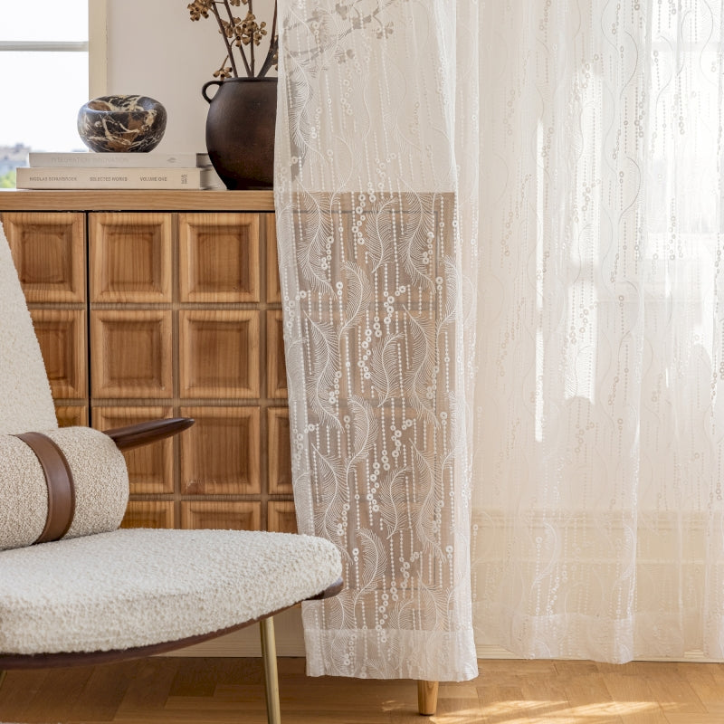 a white chair sitting in front of a window